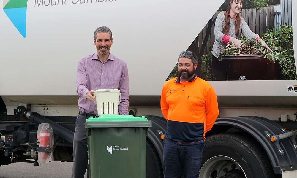 Environmental Sustainability Officer Aaron Izzard and Waste Management employee Aaron Schultz are encouraging residents to divert organic waste away from landfill by using the FOGO bin, instead of the general waste bin.