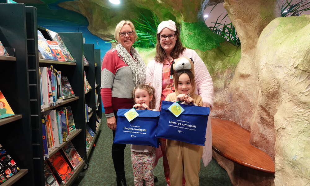 Friends of the Library Mount Gambier President Chris Lloyd and Mount Gambier Library Children’s Services Officer Bek Coates with Elsie and Alice as they receive the Literacy Learning Kits.