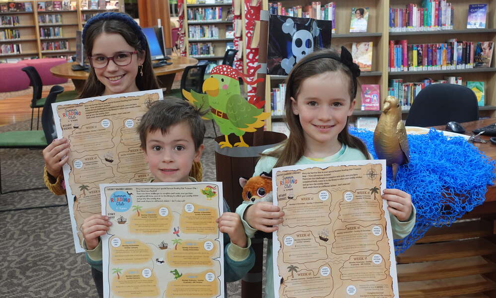 Olive, Charlie and Asher Cotton with their treasure maps!