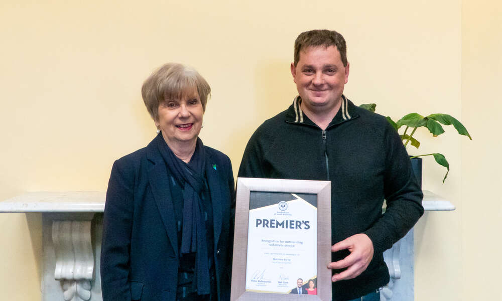 Mayor Martin presenting the Premier's Certificate of Recognition to volunteer Matthew Byrne.