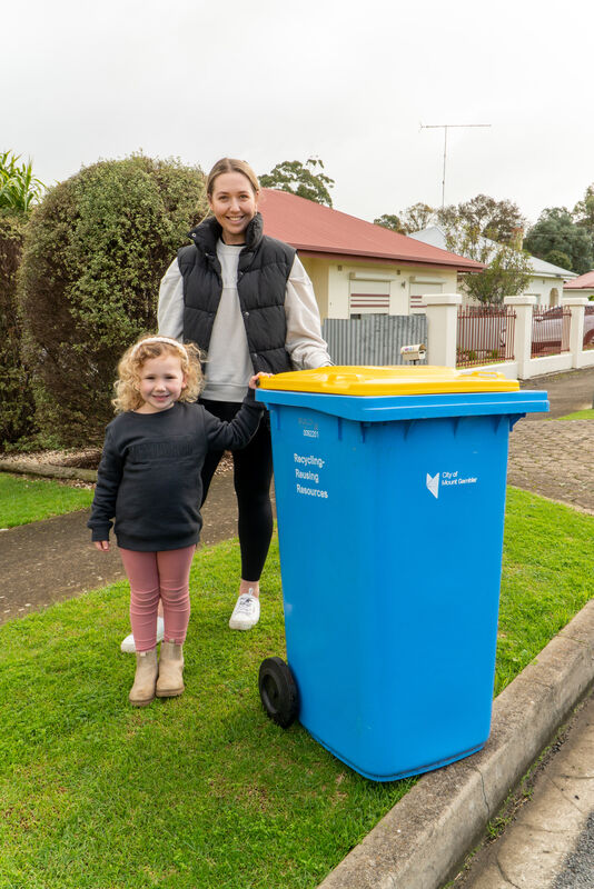 Kahlia and Bo Egan are ready to put their recycling bin on the kerb for collection on Monday 3 July 2023.
