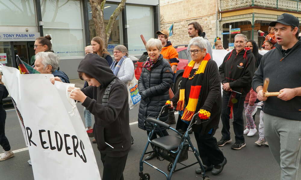 Mayor Martin and Aunty Val Brennan participate in the community march down Commercial Street West.