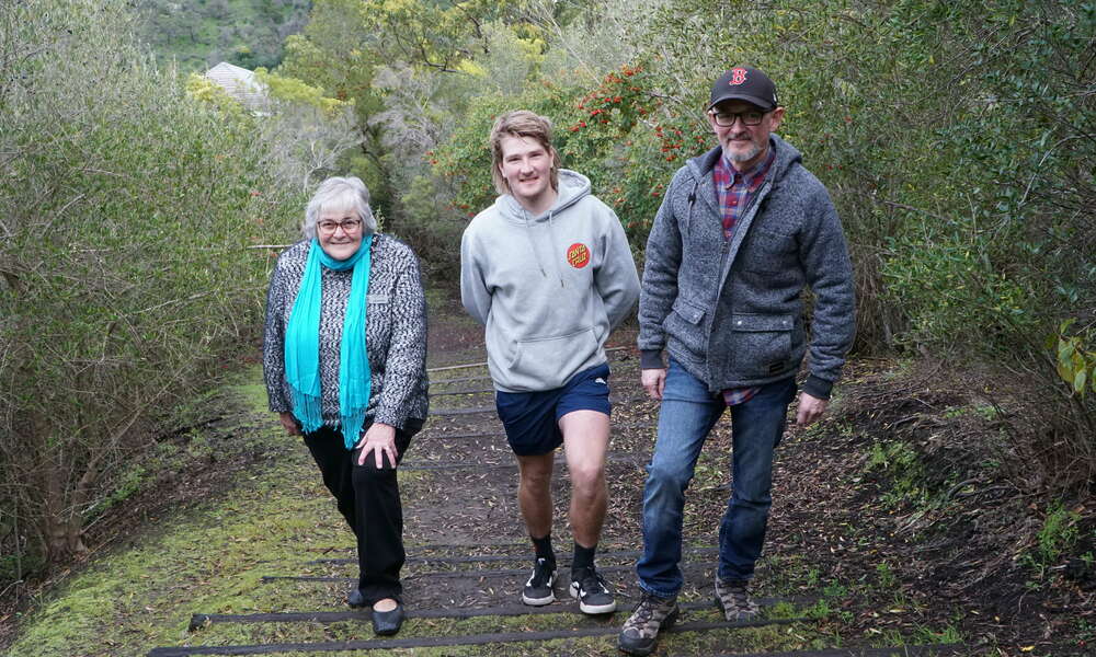 Mount Gambier History Group representative Jeanette Aslin (left) and Mount Gambier Mountain Bike Community members Shane DeJong and Peter Wheeler on the Mountain Trail at the Crater Lakes.