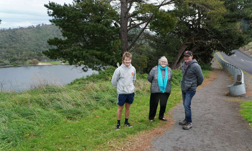 Mount Gambier Mountain Bike Community members Shane DeJong and Peter Wheeler with Mount Gambier History Group representative Jeanette Aslin at the Crater Lakes.