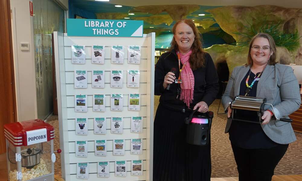 Manager Library and Community Development Georgina Davison and Team Leader Library Operations Sally Mann with items available to borrow through the Library of Things.