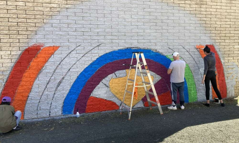Uniting Communities engaged with artist Guiyong Zhu to work with local community members to develop and paint the mural.