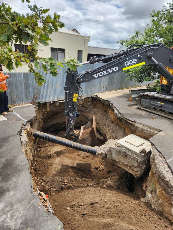 The first step was to excavate the loose material from the base and sides of the sinkhole.