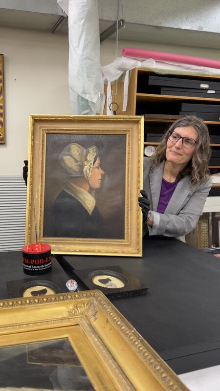 Riddoch staff member Melissa Horton works with paranormal specialists to investigate an oil painting of Helen Riddoch by an unknown artist.