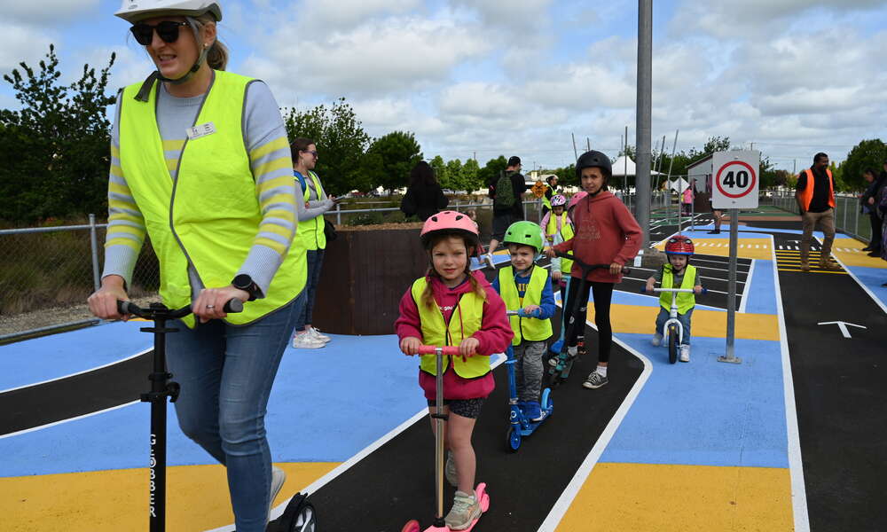 Gladigau Park Kindergarten educator Kate Ellis and children enjoy the new learn to ride mini streetscape at the Railway Lands.