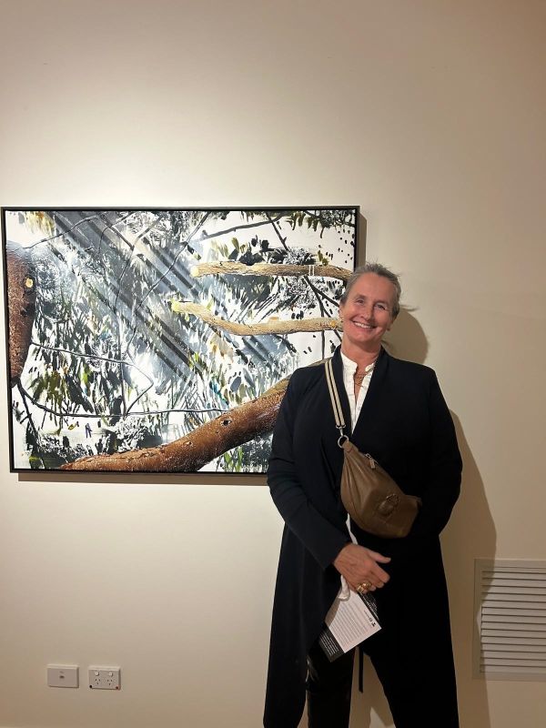 Jill McFarlane’s daughter Anna Hart is pictured beside William Mackinnon’s painting Family Tree featured as part of the exhibition Almost Here, Almost Now currently on display at The Riddoch Arts and Cultural Centre.