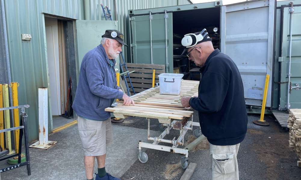 Rob Burford and Dave Norton space pickets on the rails.
