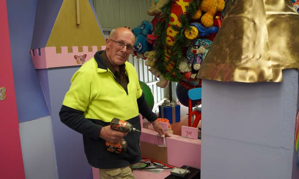 Parade volunteer Alan Richardson works on one of the floats for the 2025 Christmas Parade.