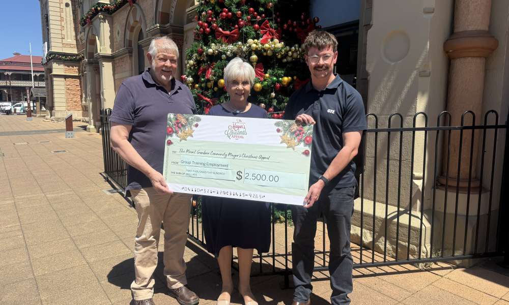 Group Training Employment Board Chair Ray Herbert and Field Operation Manager Kyle Gleed present a donation of $2,500 to Mayor Martin.