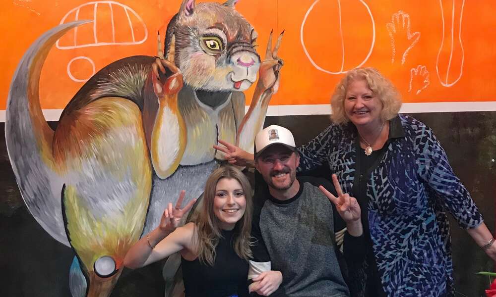 Artist Mel Cecotti (left), Ben Deering and City of Mount Gambier Manager Tourism and Economic Development Donna Foster are ‘photobombed’ by ‘Simo’.