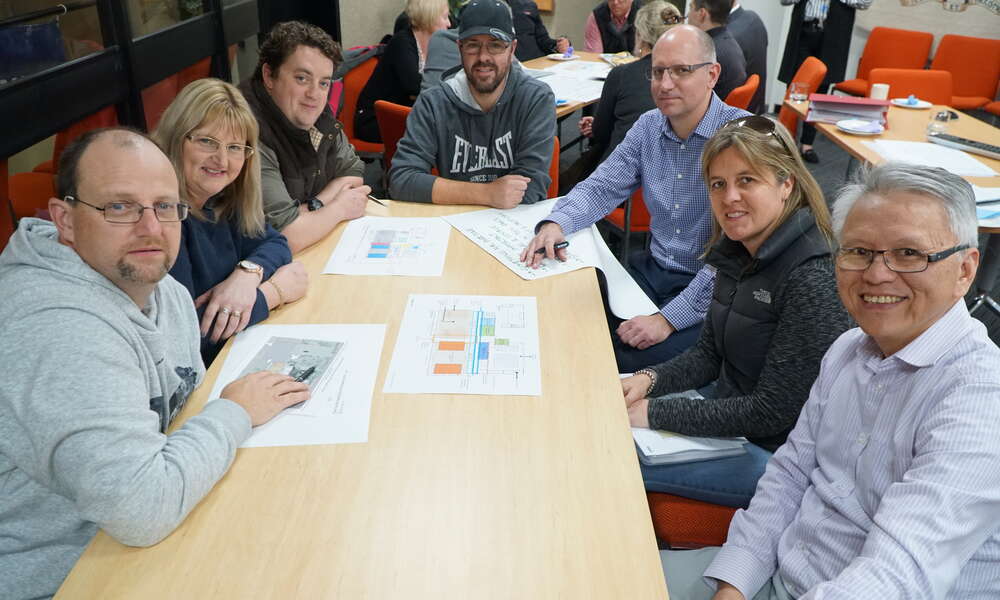 CRG members Scott Martin (left), Yvette Holmes, Jamie MacDonald, Phil Lowe,  DesignInc Managing Director Richard Stafford, Julie Moran and Mayor Andrew Lee discuss plans for the proposed Mount Gambier Regional Sport and Recreation Centre.