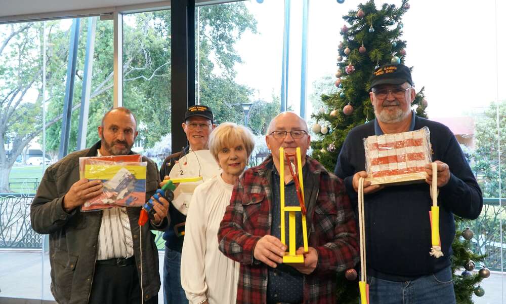 Mount Gambier Men's Shed members Peter Kukola, Ian Bond,  Mayor Martin, George Renzi and Peter Heness with examples of the wooden toys that will be handmade and donated to the appeal for families in need at Christmas.