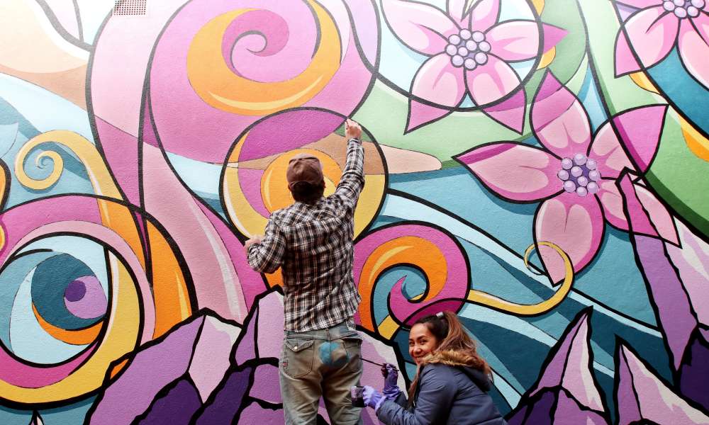 Wonder wall: visual artists Justin and Aileen Clarke have collaborated with Tenison Woods College students to transform a blank wall in a CBD thoroughfare into the city’s newest public art project. Photo credit: Kate Hill