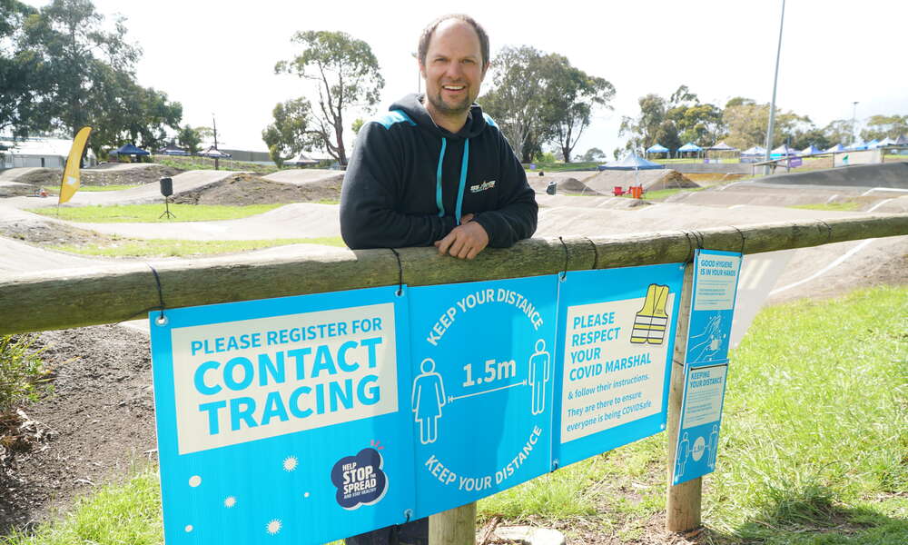 Blue Lake BMX President Stephen Jones with the event support package corflute signs placed around the track for the BMX SA 2020 Championships.
